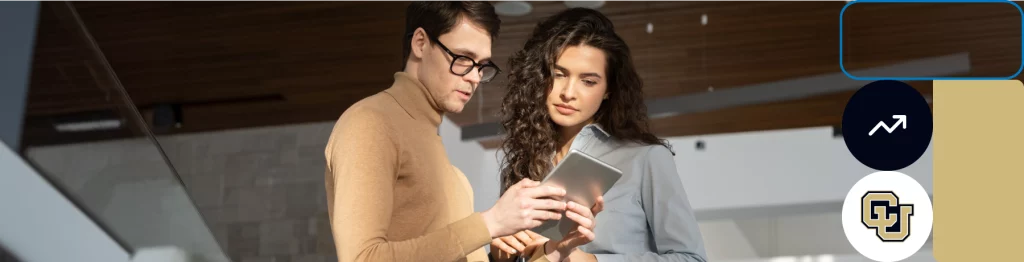 Two people looking at a tablet, University of Colorado logo, indoor modern setting